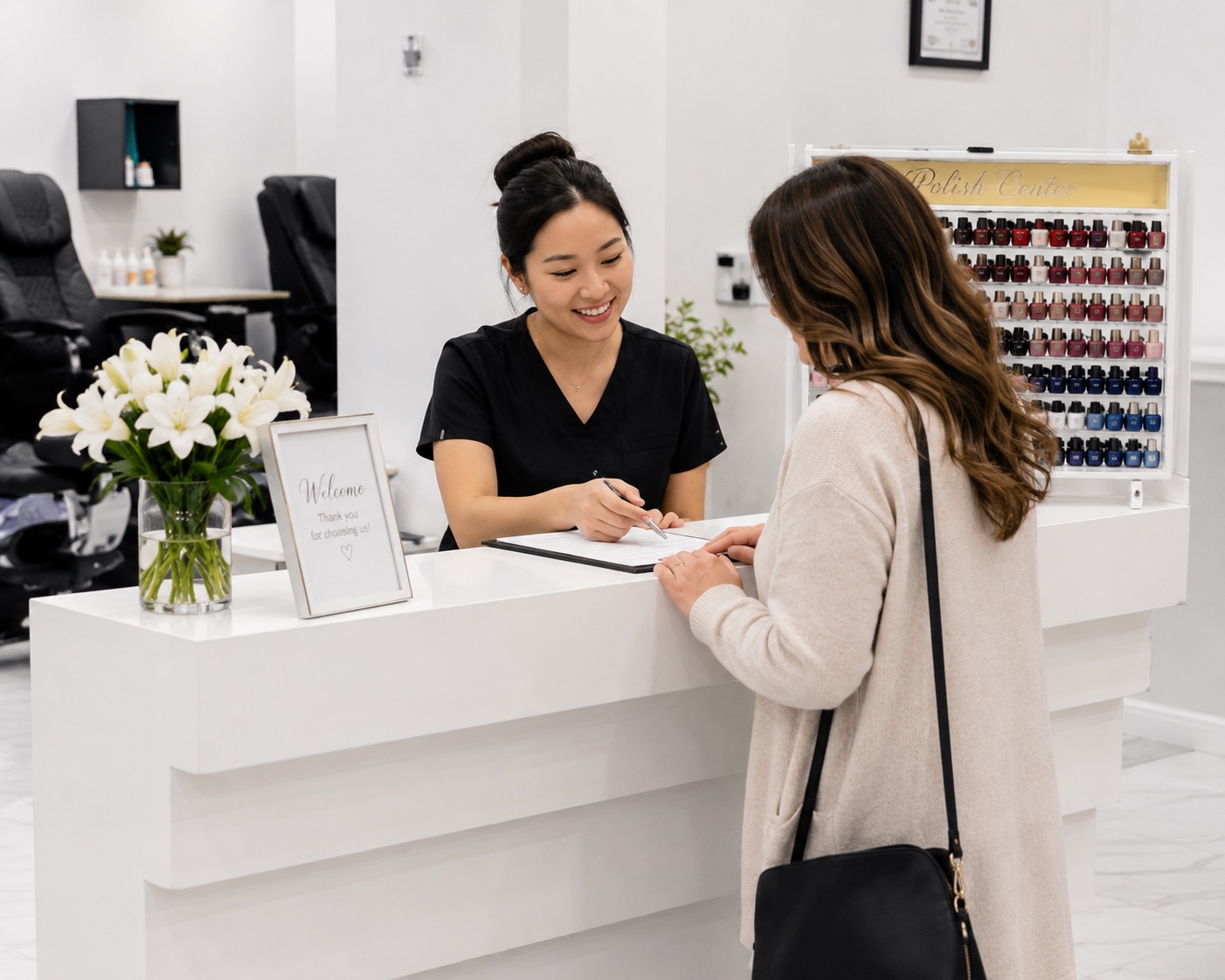 Two salon team members warmly embracing a returning guest at the front desk